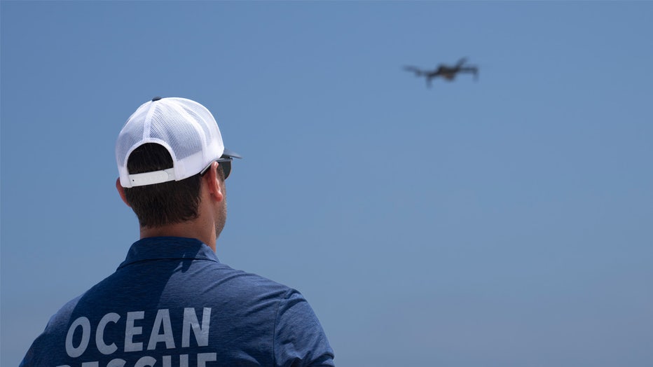 Cary Epstein, lifeguarding supervisor, monitors the waters from above as he operates a drone for a shark patrol flight at Jones Beach State Park, Thursday, July 6, 2023, in Wantagh, N.Y. Drones are sweeping over the ocean off the coast of New York’s Long Island to patrol the waters for any danger possibly lurking. (AP Photo/John Minchillo)