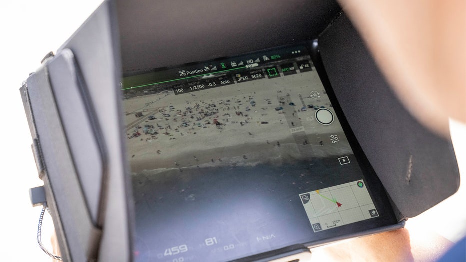 Cary Epstein, lifeguarding supervisor, monitors the waters from above as he operates a drone for a shark patrol flight at Jones Beach State Park, Thursday, July 6, 2023, in Wantagh, N.Y. Drones are sweeping over the ocean off the coast of New York’s Long Island to patrol the waters for any danger possibly lurking. (AP Photo/John Minchillo)