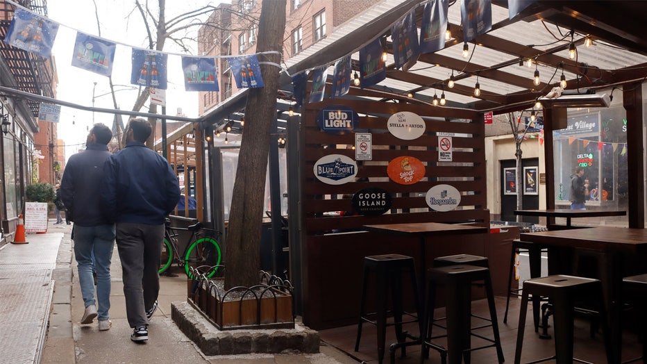 NEW YORK, NY - MARCH 5: People walk past an empty restaurant outdoor dining shed on Christopher Street in the West Village on March 5, 2023, in New York City. (Photo by Gary Hershorn/Getty Images)