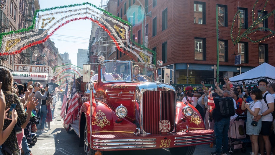 NEW YORK, NEW YORK - SEPTEMBER 25: Spectators watch a FDNY vehicle during The Grand Procession at The Feast Of San Gennaro Festival in Little Italy on September 25, 2021 in New York City. This years theme honored members of the FDNY and First Responders on the 20th anniversary of September 11. (Photo by Alexi Rosenfeld/Getty Images)