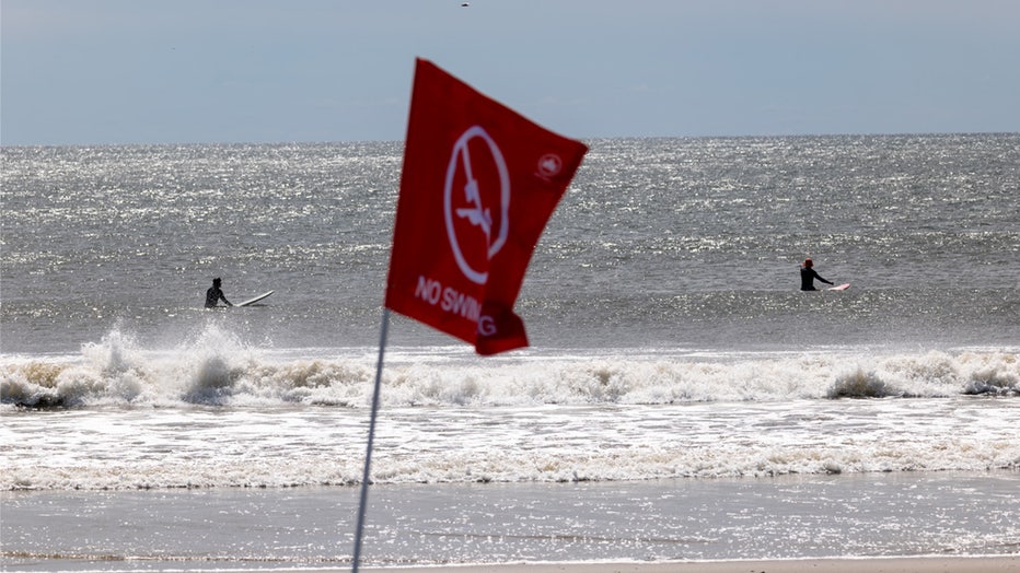 NEW YORK, NEW YORK - AUGUST 31: Surfers ride waves at Rockaway Beach in New York as high surf from Hurricane Franklin delivers strong rip tides and large waves to most of the eastern seaboard on August 31, 2023 in New York City. Numerous beaches across New York and Long Island were closed to swimming as a result of rip tides from the storm which has now moved out into the Atlantic. (Photo by Spencer Platt/Getty Images)