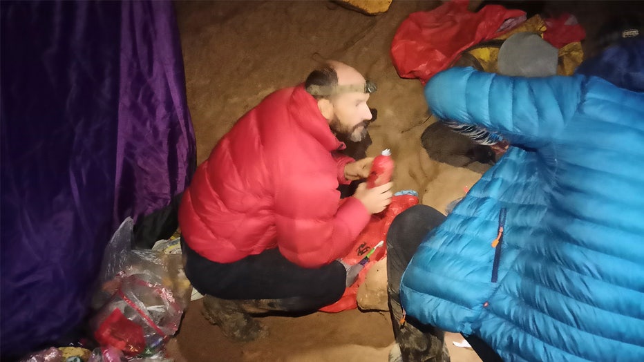 American caver Mark Dickey, left, 40, talks to a colleague inside the Morca cave near Anamur, southern Turkey, Thursday, Sept. 7, 2023. Turkish and international cave rescue experts are working to save an American speleologist trapped at a depth of more than 1,000 meters (3,280 feet) in a cave in southern Turkey after he became ill. (Turkish Government Directorate of Communications via AP)