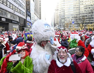 NEW YORK, USA - DECEMBER 10: People dressing up as Santa Clause gather during SantaCon day in Manhattan, New York, United States on December 10, 2022. (Photo by Fatih Aktas/Anadolu Agency via Getty Images)