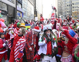 NEW YORK, USA - DECEMBER 10: People dressing up as Santa Clause gather during SantaCon day in Manhattan, New York, United States on December 10, 2022. (Photo by Fatih Aktas/Anadolu Agency via Getty Images)