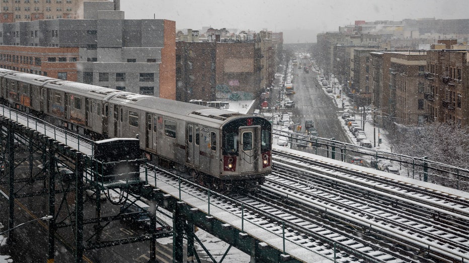 NEW YORK, NY - FEBRUARY 07: A subway train travels on the elevated track over the snow covered streets on February 7, 2021 in Bronx borough of New York City. The second snowstorm in a week is expected to drop up to eight inches of snow in the New York City area. (Photo by David Dee Delgado/Getty Images)