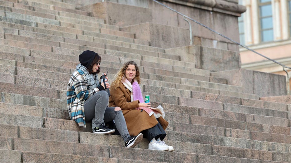 FILE - Women sit on the steps in front of Helsinki Cathedral in early March 2024 in Helsinki, Finland. (Photo by Takimoto Marina/SOPA Images/LightRocket via Getty Images)