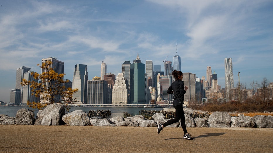 NEW YORK, NY - FEBRUARY 8: A jogger runs along the Brooklyn Bridge Park, February 8, 2017 in the Brooklyn borough of New York City. As temperatures touched 60 degrees on Wednesday, the city is preparing for up to a foot of snow on Thursday. (Photo by Drew Angerer/Getty Images)