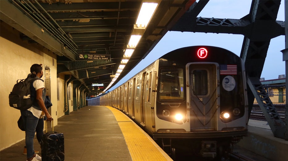 NEW YORK, NY - AUGUST 3: A woman waits to board an "F" train at the Smith-9 Sts subway station on August 3, 2023, in New York City. (Photo by Gary Hershorn/Getty Images)