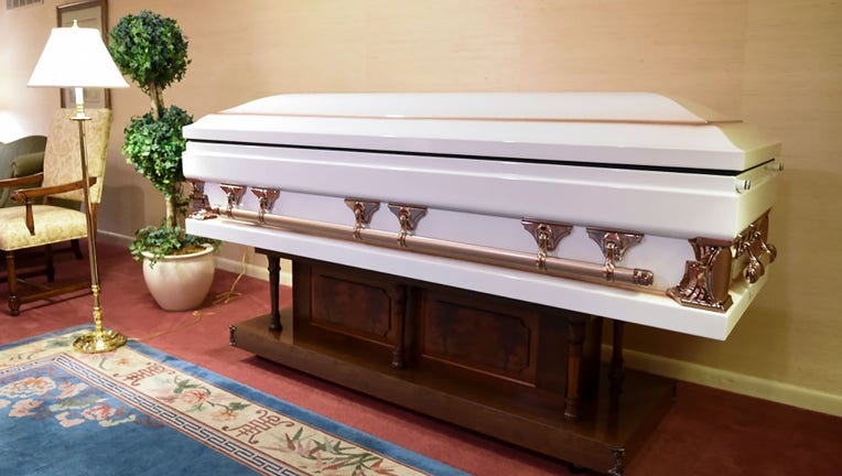 FILE - A white casket in the funeral home. (Photo by Ben Hasty/MediaNews Group/Reading Eagle via Getty Images)