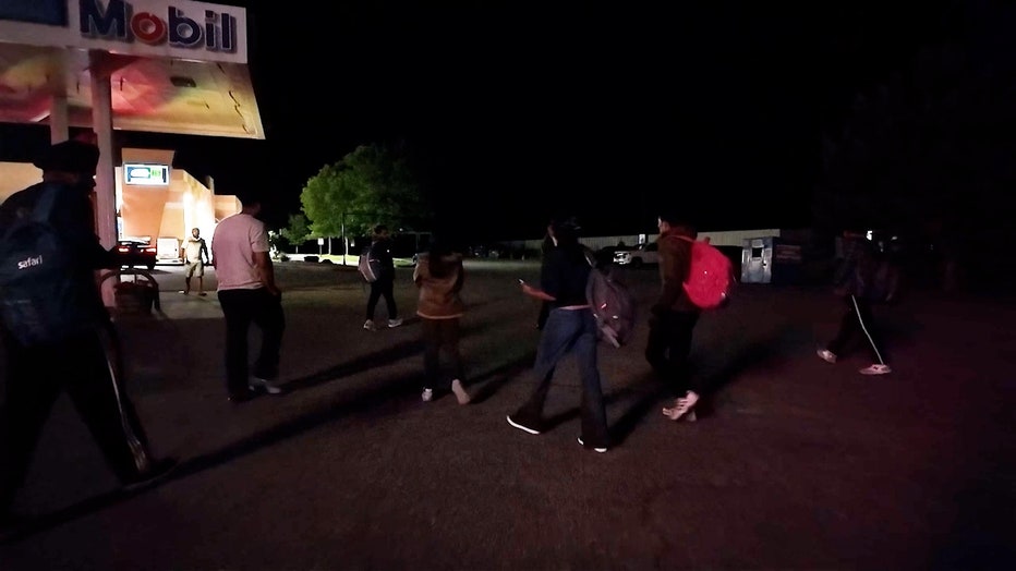 Migrants find a meeting point at a Plattsburgh, New York, gas station, 30 miles from the U.S.-Canada border.