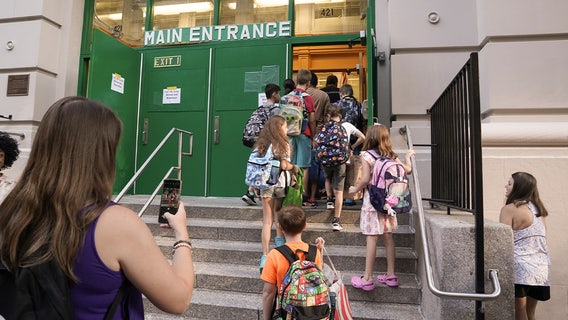 NYC kids return to class with new rules and new schools