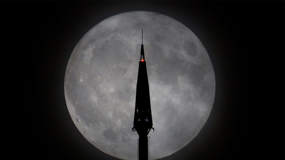 Blue Supermoon Rises in New York City
JERSEY CITY, NJ - AUGUST 30: The Blue Supermoon rises behind the antenna on top of One World Trade Center in New York City on August 30, 2023, as seen from Jersey City, New Jersey. (Photo by Gary Hershorn/Getty Images)