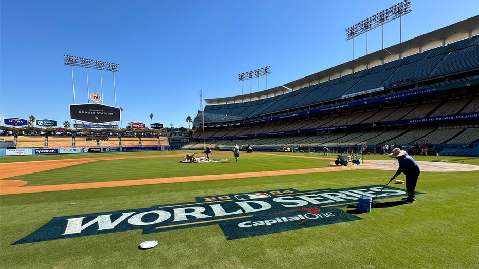 Los Angeles, CA - October 24: A member of the grounds crew paints the World Series logo on the field the day before game 1 of a World Series baseball game at Dodger Stadium in Los Angeles on Thursday, October 24, 2024.(Photo by Keith Birmingham/MediaNews Group/Pasadena Star-News via Getty Images)