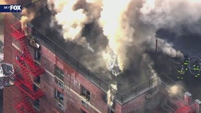 FDNY battles fire burning through Queens building roof