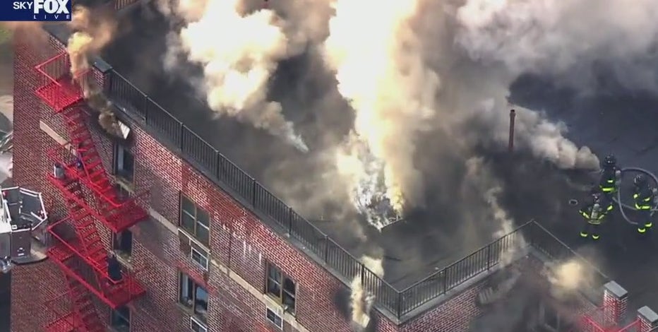 FDNY battles fire burning through Queens building roof