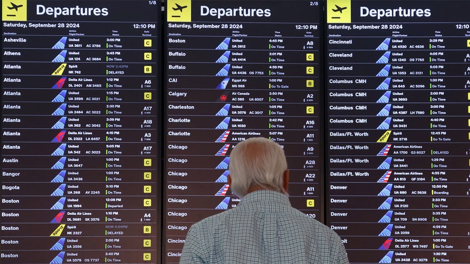 NEWARK, NJ - SEPTEMBER 28: A traveler looks at a departure board in Terminal A at Newark Liberty International Airport on September 28, 2024, in Newark, New Jersey. (Photo by Gary Hershorn/Getty Images)
