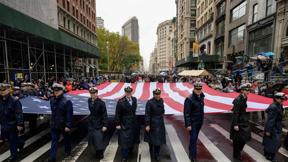 US Navy personnel carry a US flag as they march during the annual Veterans Day Parade in New York on November 11, 2022. (Photo by ANGELA WEISS / AFP) (Photo by ANGELA WEISS/AFP via Getty Images)
