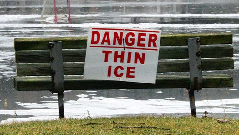 A Danger Thin Ice sign with the remnants of a pond hockey rink beyond Friday Jan. 12, 2018 in Clifton Park, NY. (Photo by John Carl DAnnibale /Albany Times Union via Getty Images)
