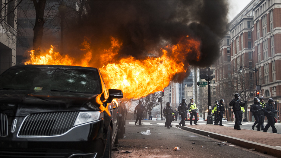 WASHINGTON, USA - JANUARY 20: Anti-Trump protestors set a limousine on fire during clashes with police after President Trump was sworn into office in Washington, USA on January 20, 2017. (Photo by Samuel Corum/Anadolu Agency/Getty Images)