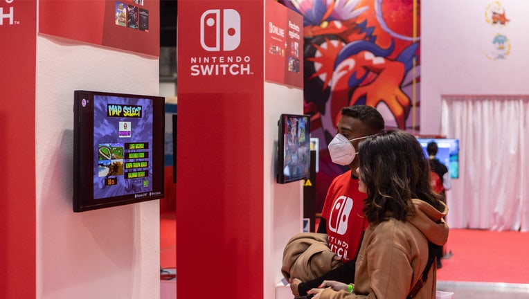 MILAN, ITALY - NOVEMBER 25: People play video games at the Japanese publisher Nintendo Switch's stand during Milan Games Week & Cartoomics 2022 at Fiera Milano Rho on November 25, 2022 in Milan, Italy. Milan Games Week & Cartoomics is the most complete Italian event dedicated to video games, esports, digital entertainment and geek culture, cosplayers, comics, publishing and entertainment. (Photo by Emanuele Cremaschi/Getty Images)