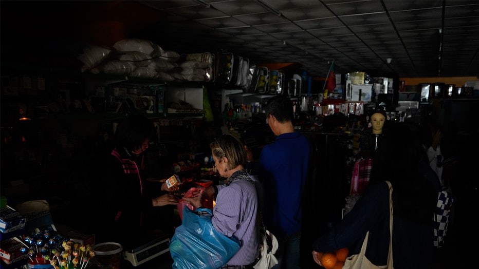 LISBON, PORTUGAL - APRIL 28: People buy groceries in a store during a shutdown of electricity on April 28, 2025 in Lisbon, Portugal. There was a widespread power outage today in Spain and Portugal and parts of France. (Photo by Adri Salido/Getty Images)
