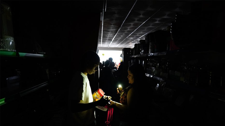 LISBON, PORTUGAL - APRIL 28: People buy groceries in a store during a shutdown of electricity on April 28, 2025 in Lisbon, Portugal. There was a widespread power outage today in Spain and Portugal and parts of France. (Photo by Adri Salido/Getty Images)