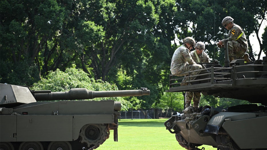 US soldier sit on top of a M1 Abrams tank during a media preview of the Army's Parade at West Potomac Park in Washington, DC on June 11, 2025. A military parade and celebration of the 250th birthday of the US Army will be held in Washington, DC, on June 14, which also coincides with President Donald Trump's 78th birthday. (Photo by Mandel NGAN / AFP) (Photo by MANDEL NGAN/AFP via Getty Images)