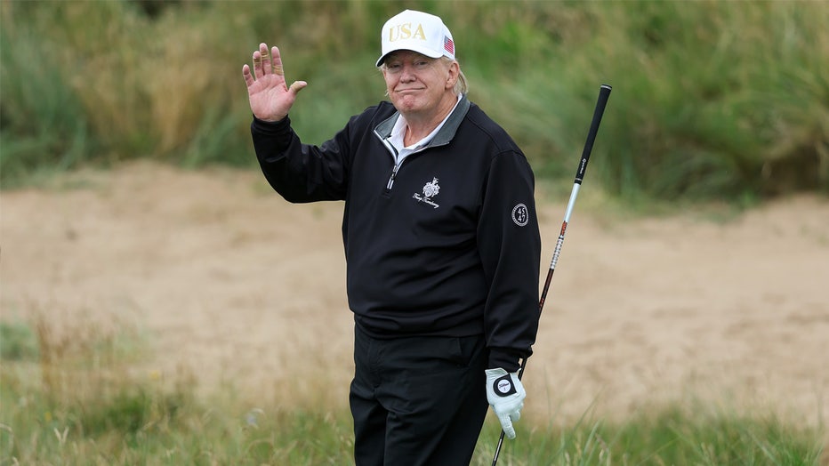 BALMEDIE, SCOTLAND - JULY 29: U.S. President Donald Trump holds a driver after teeing off during the opening of his new golf course at his Trump International Golf links resort on July 29, 2025 in Balmedie, Scotland. President Trump is visiting Scotland in a trip that’s part-vacation, part-work, as he stayed at his Trump Turnberry golf course, followed by Trump International Golf Links in Aberdeenshire, between July 25 to 29. (Photo by Jeff J Mitchell/Getty Images)