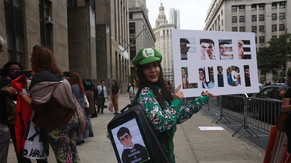 NEW YORK, NEW YORK - SEPTEMBER 16: Supporters of Luigi Mangione gather outside of Manhattan Criminal Court for a hearing in the murder of UnitedHealth Care CEO Brian Thompson on September 16, 2025, in New York City. Mangione is accused of murdering UnitedHealthcare CEO Brian Thompson late last year. He is facing 11 counts for the December 4 shooting of Thompson outside a midtown Manhattan hotel, which set off a massive manhunt. He is also facing federal charges of murder and other charges in Pennsylvania, where he was arrested. (Photo by Spencer Platt/Getty Images)