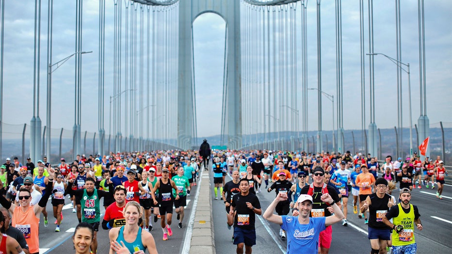 TOPSHOT - Runners cross the Verrazano Bridge before competing in the 52nd Edition of the New York City Marathon on November 5, 2023. (Photo by Kena Betancur / AFP) (Photo by KENA BETANCUR/AFP via Getty Images)
