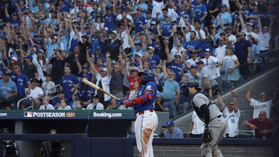 TORONTO, ON - OCTOBER 5 - Toronto Blue Jays first baseman Vladimir Guerrero Jr. (27) and New York Yankees catcher Austin Wells (28) watch the flight of the ball as he hits a grand slam as the Toronto Blue Jays play the New York Yankees in game two of the ALDS MLB Playoff series at Rogers Centre in Toronto. October 5, 2025. (Photo by Steve Russell/Toronto Star via Getty Images)
