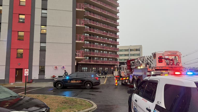 Police and fire trucks outside an apartment building.