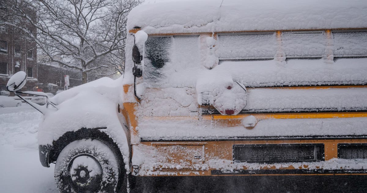Snow covered school bus and cleared roads after winter storm