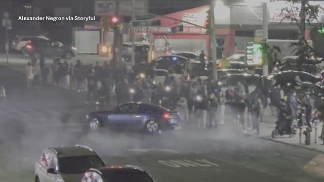 3 people jump on NYPD car, crack windshield during Queens street takeover