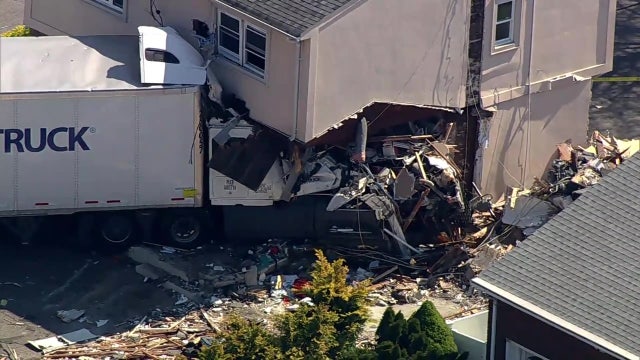 Tractor-trailer still lodged in Clifton business more than day after Route 3 crash