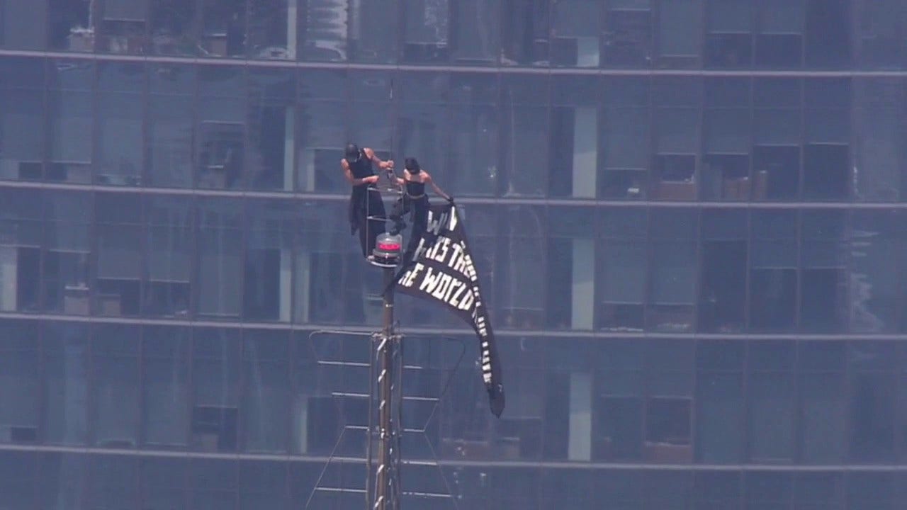 LIVE: 2 people climb to top of Empire State Building; raise flag from spire