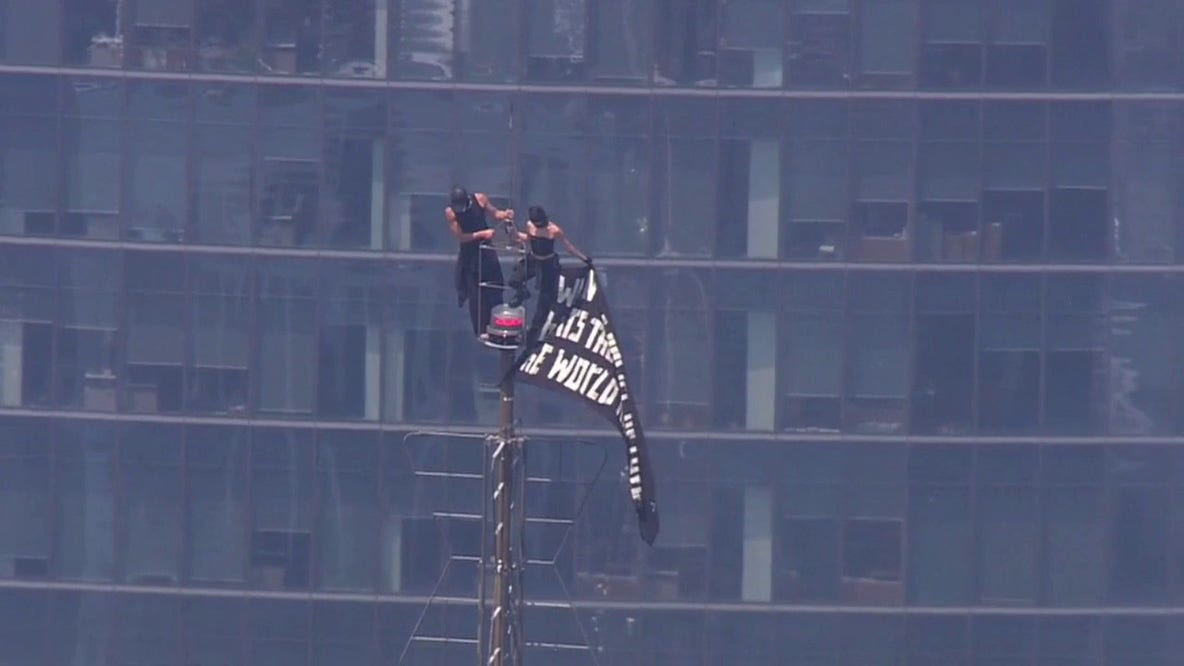 LIVE: 2 people climb to top of Empire State Building; raise flag from spire