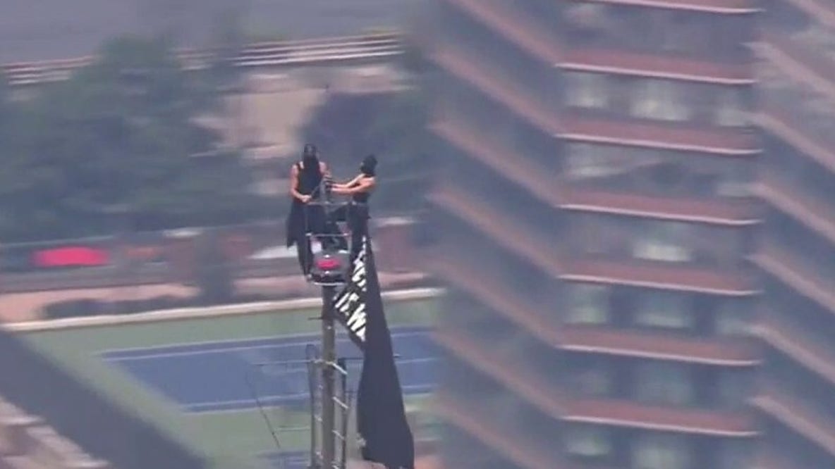 LIVE: 2 people climb to top of Empire State Building; raise flag from spire