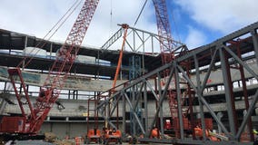 Construction milestone: First roof truss of new Bucks arena raised into position