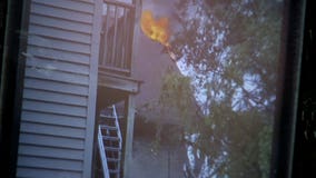 "Hanging their children out the side:" Neighbors come to rescue of family trapped in burning home