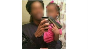 Photo showing toddler with finger on trigger of gun sparks outrage, concern in Chicago area