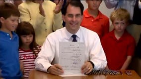 Governor Walker back in the state and busy Monday, signing three bills, commenting on WEDC and GAB