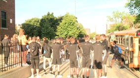 UWM soccer team members welcome Hartford University School students back to class