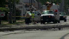 Dump truck with raised box strikes power lines, takes out power poles