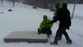 Taking a break from shoveling, folks in Milwaukee enjoy HUGE waves on Lake Michigan, fun sledding