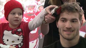 Bald is beautiful! Badgers football players have their heads shaved for a very good cause