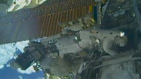 Spacewalking astronauts set up TV cameras for arriving ships