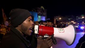 Estimated 1,200, including Dontre Hamilton's family, take part in protests during GOP debate