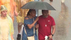 Summerfest goers handle stormy weather in stride, donning ponchos to dance the night away