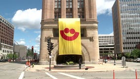 "Summerfest is in full bloom" with massive banner hanging from City Hall